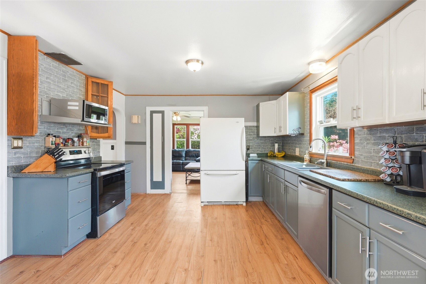 21716 State Rte 530 Northeast Arlington, WA 98223 - Photo 17 of 38 a kitchen with stainless steel appliances wooden floors and wooden cabinets