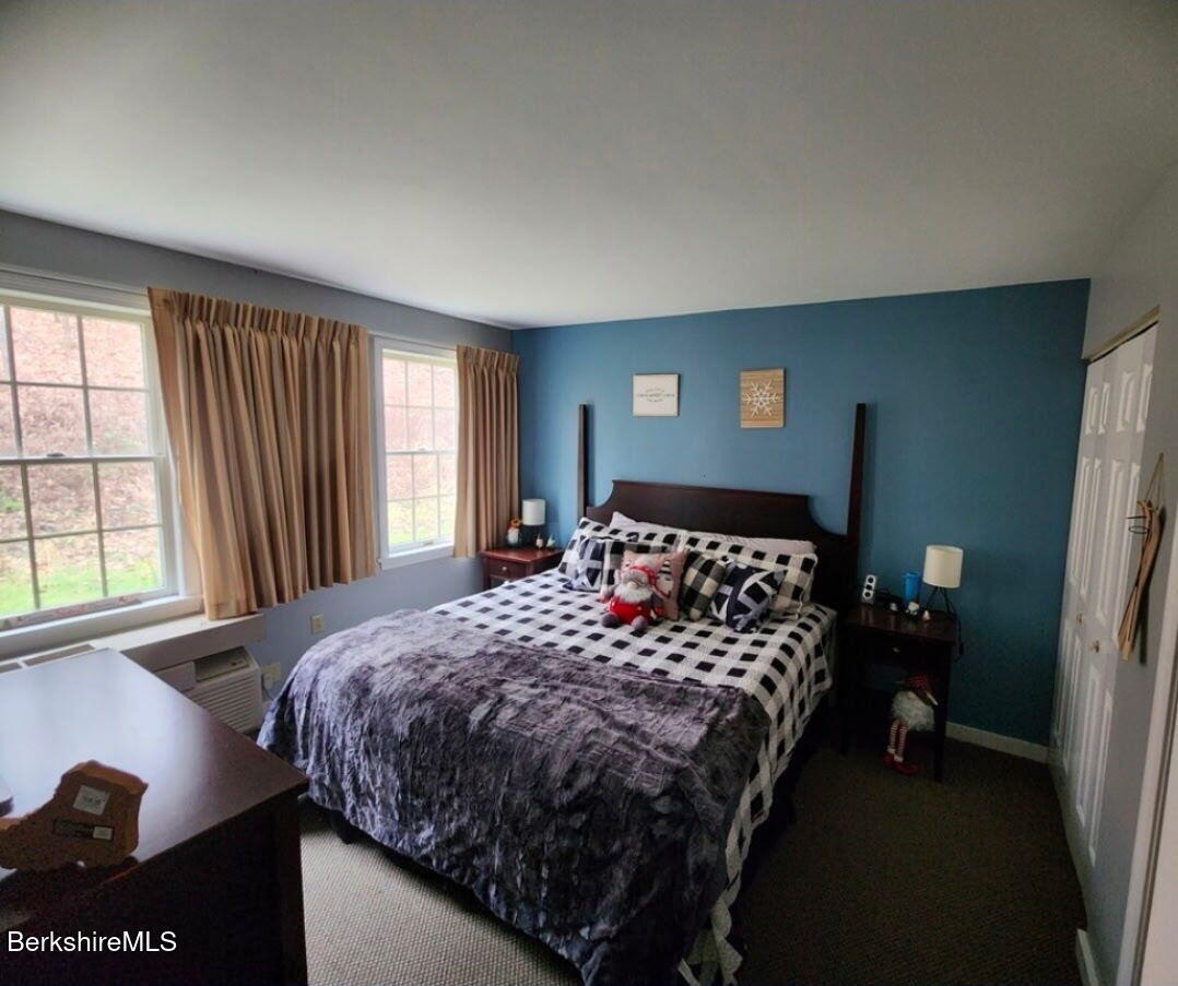 37 Corey Road, Unit 521 Hancock, MA 01237 - Photo 2 of 18 a bed sitting in a bedroom next to a window