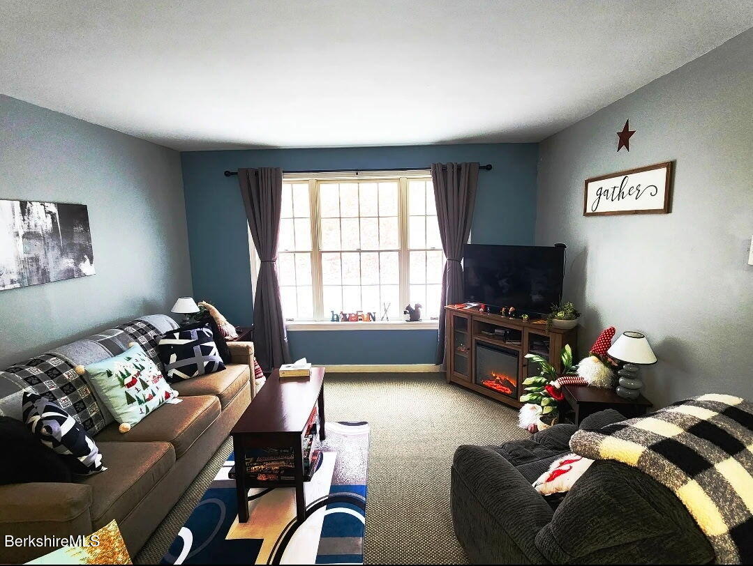 37 Corey Road, Unit 521 Hancock, MA 01237 - Photo 3 of 18 a living room with furniture and a flat screen tv