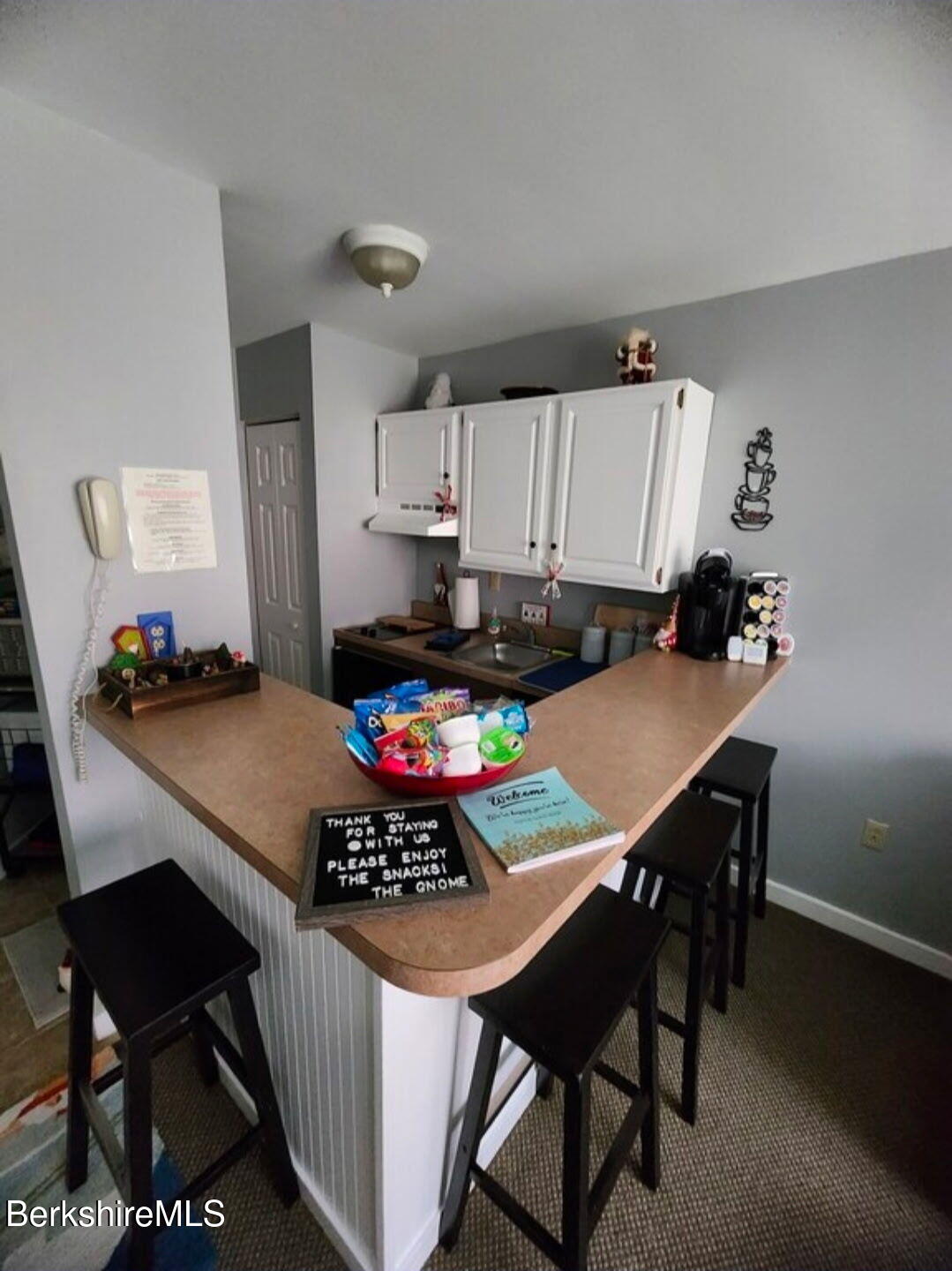 37 Corey Road, Unit 521 Hancock, MA 01237 - Photo 7 of 18 a kitchen with a table chairs a stove a dining table and chairs