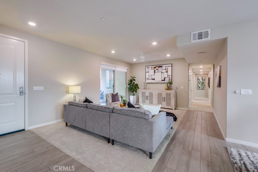 136 Tribeca Irvine, CA 92612 - Photo 14 of 70 a living room with furniture and a wooden floor