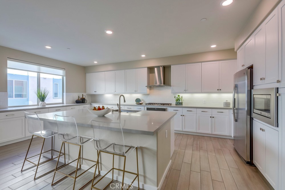 136 Tribeca Irvine, CA 92612 - Photo 2 of 70 a large kitchen with lots of counter space and stainless steel appliances