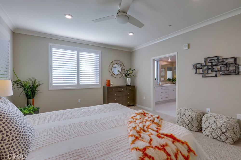 136 Tribeca Irvine, CA 92612 - Photo 25 of 70 a bedroom with a large bed and a chandelier