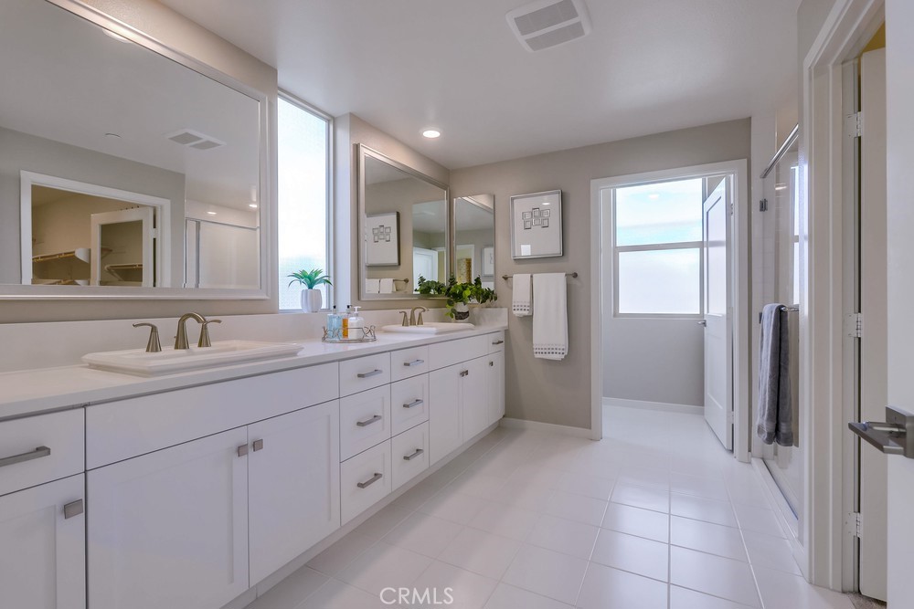 136 Tribeca Irvine, CA 92612 - Photo 28 of 70 a spacious bathroom with a granite countertop sink mirror and a