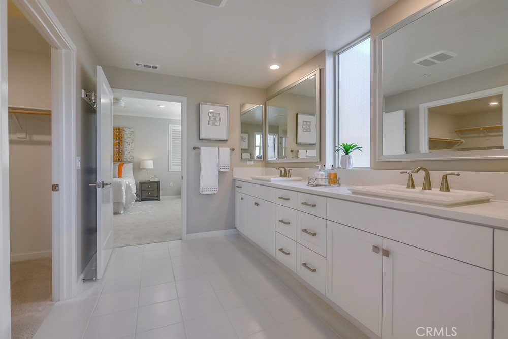 136 Tribeca Irvine, CA 92612 - Photo 31 of 70 a bathroom with double sink and a mirror