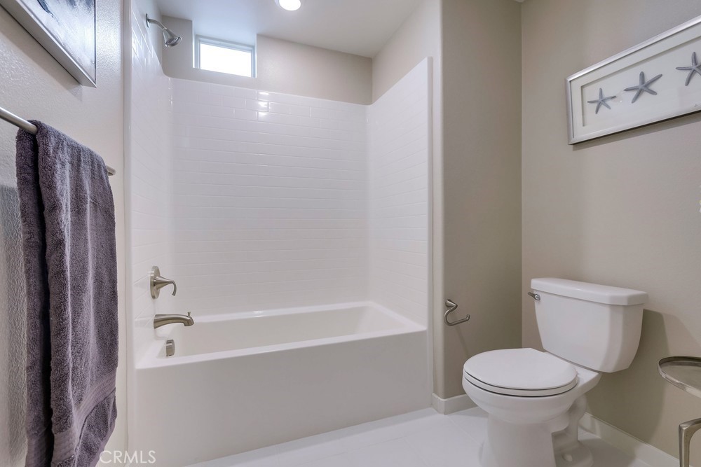 136 Tribeca Irvine, CA 92612 - Photo 37 of 70 a bathroom with a toilet and a bathtub
