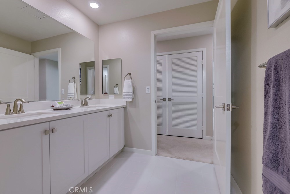136 Tribeca Irvine, CA 92612 - Photo 38 of 70 a bathroom with a double vanity sink mirror and shower