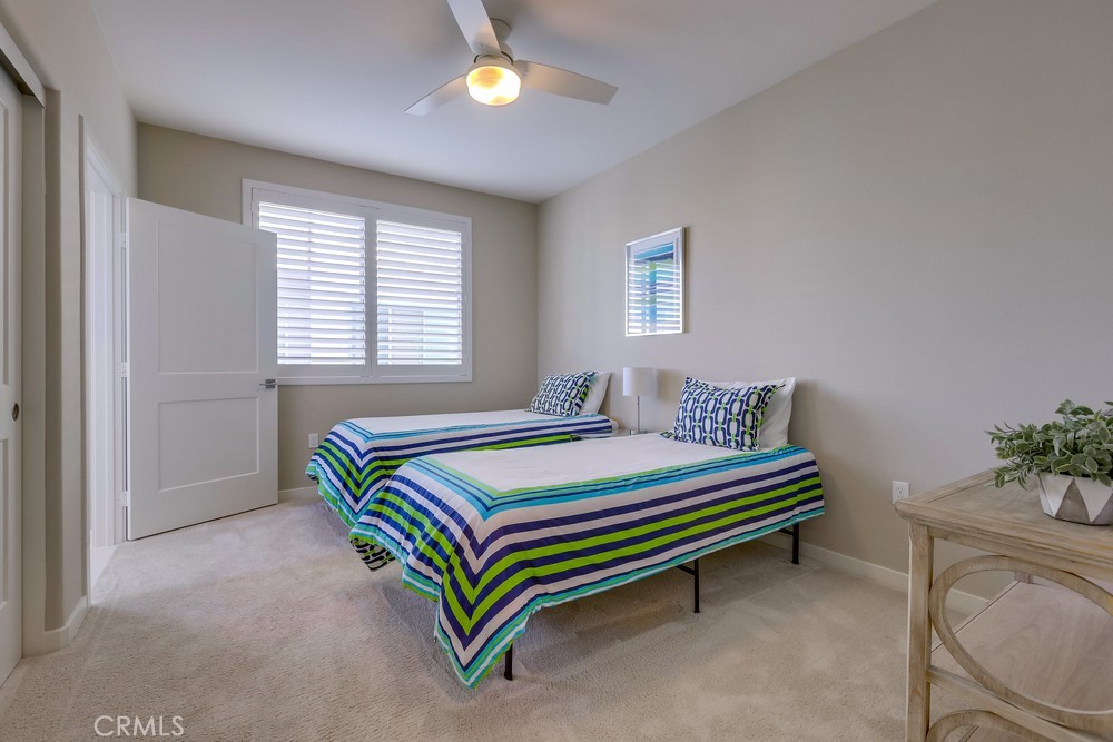 136 Tribeca Irvine, CA 92612 - Photo 39 of 70 a bedroom with a bed and a potted plant