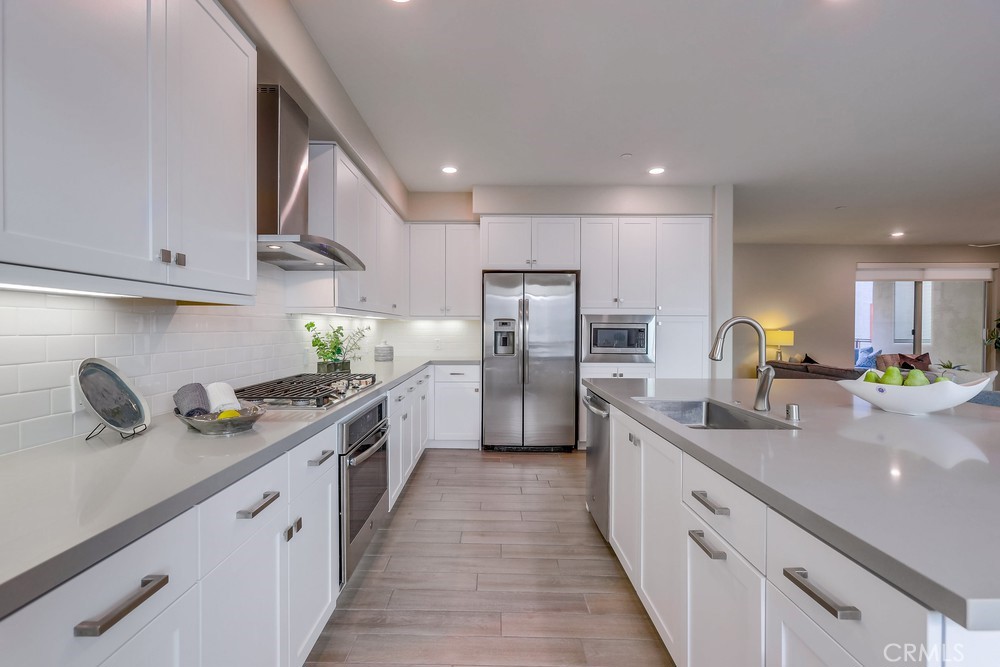 136 Tribeca Irvine, CA 92612 - Photo 4 of 70 a large kitchen with stainless steel appliances lots of counter space sink and cabinets