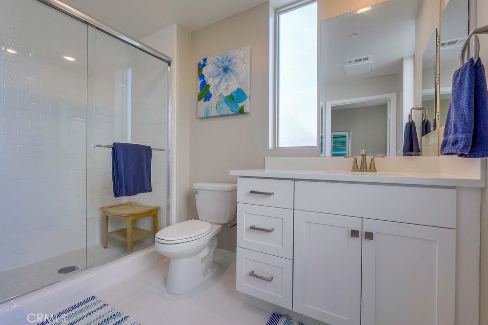 136 Tribeca Irvine, CA 92612 - Photo 42 of 70 a bathroom with a sink a toilet and a mirror