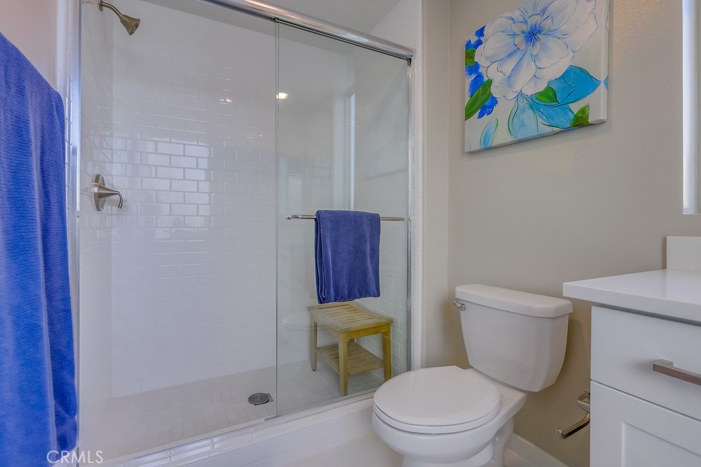 136 Tribeca Irvine, CA 92612 - Photo 43 of 70 a white toilet sitting next to a bathroom sink and a shower