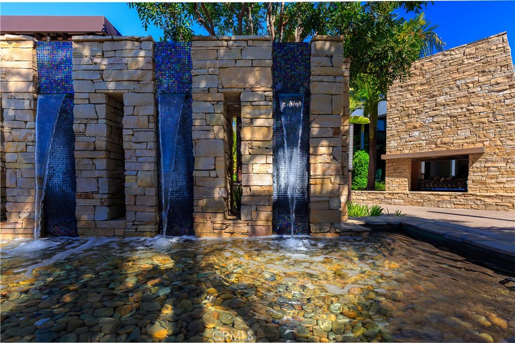 136 Tribeca Irvine, CA 92612 - Photo 68 of 70 a backyard of a house with barbeque oven table and chairs