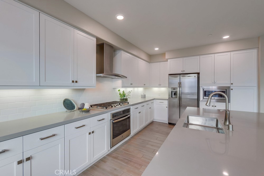 136 Tribeca Irvine, CA 92612 - Photo 7 of 70 a kitchen with refrigerator and cabinets