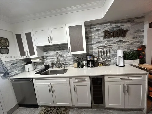a kitchen with stainless steel appliances granite countertop a sink and a stove