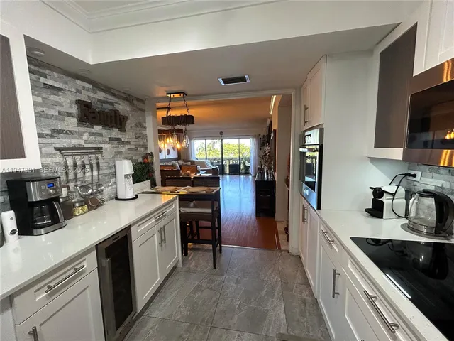 a kitchen with a sink cabinets and appliances
