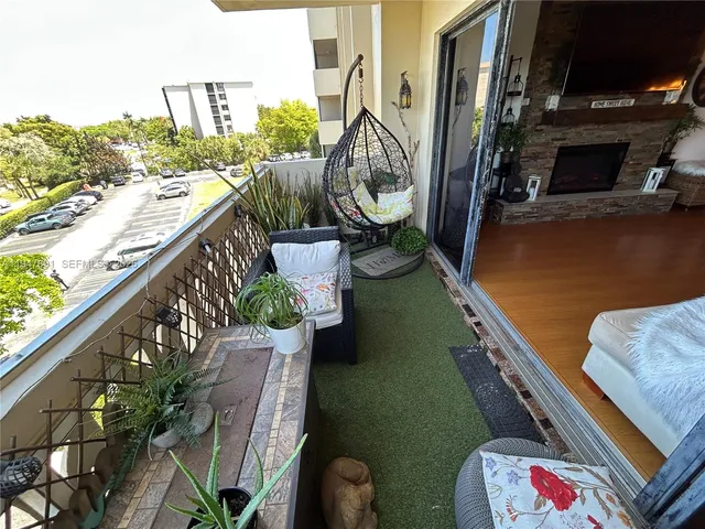 a balcony with outdoor seating and plants