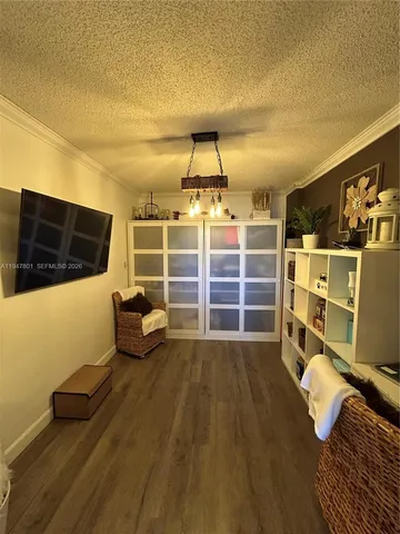a view of a livingroom with furniture and a flat screen tv