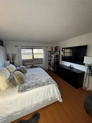 a bed room with a bed and a television