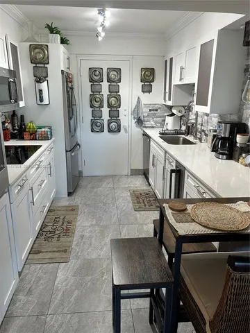 a kitchen with a stove a refrigerator and a stove top oven