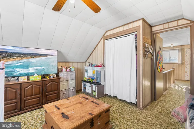 a kitchen with stainless steel appliances kitchen island granite countertop a refrigerator and microwave