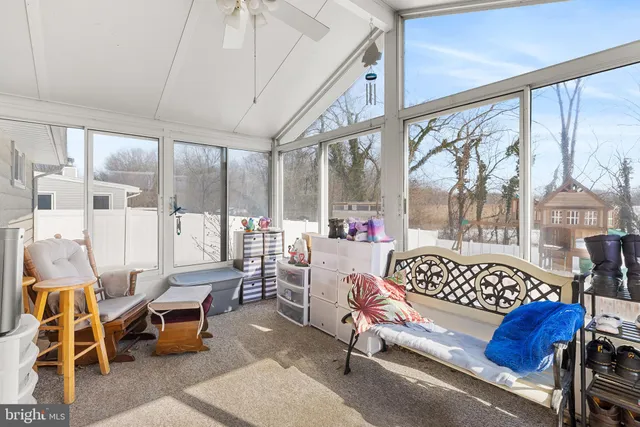 a bedroom with furniture and a large window