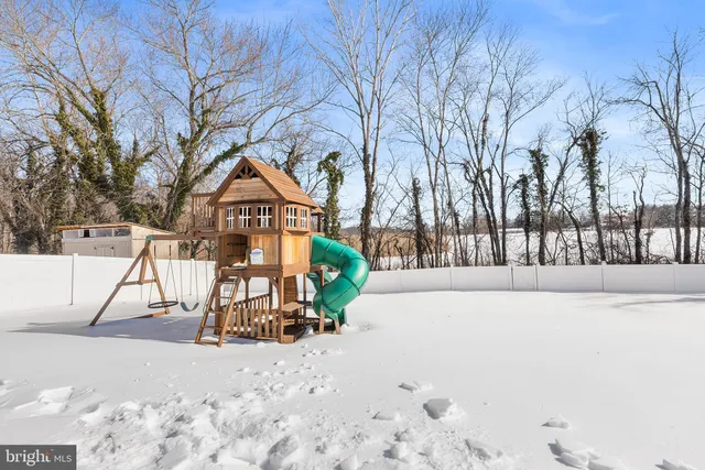 a view of a park with snow on the road