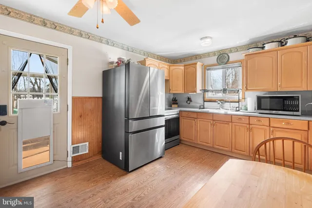 a kitchen with stainless steel appliances a refrigerator sink and cabinets