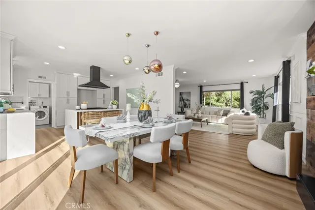 a living room with fireplace furniture and a large window