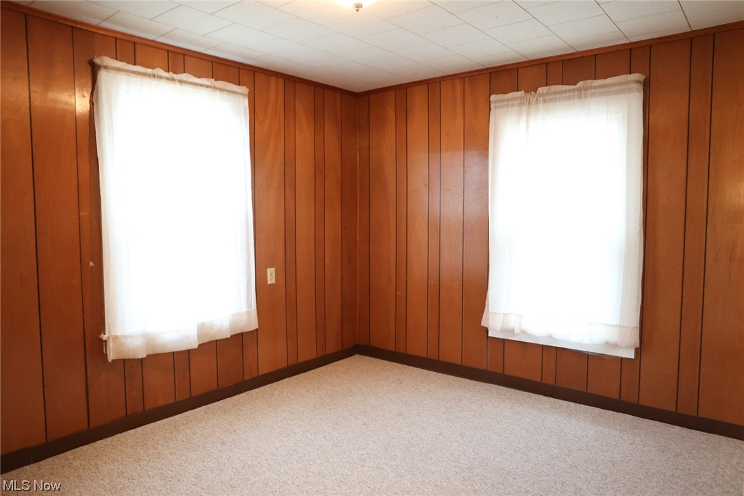 1309 Krumroy Road Akron, OH 44306 - Photo 16 of 30 Carpeted empty room with a healthy amount of sunlight