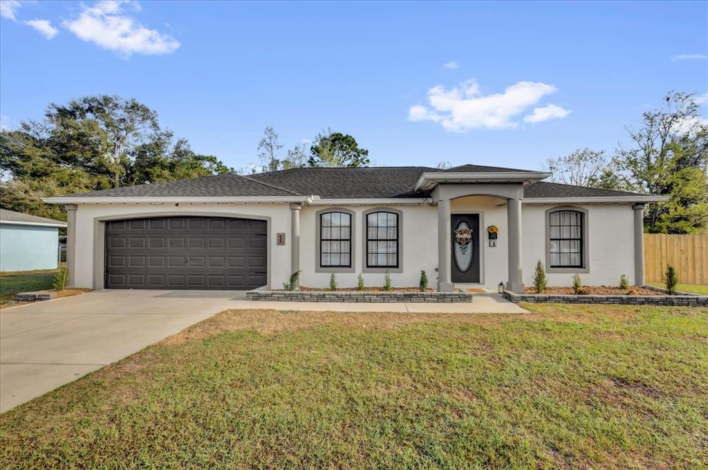 1 Hemlock Terrace Track Ocala, FL 34472 - Photo 1 of 1 a front view of a house with a garden and yard