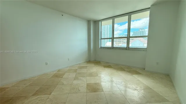 a view of an empty room with a window