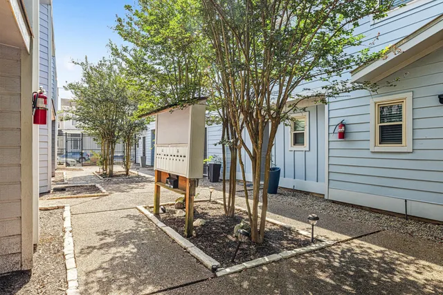 a view of a house with a tree in the yard