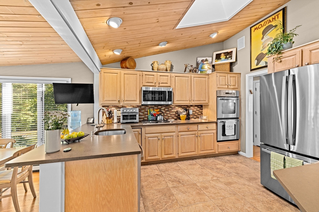 14 Aberdeen Drive Scituate, MA 02066 - Photo 15 of 42 a kitchen with stainless steel appliances granite countertop a refrigerator stove microwave and sink