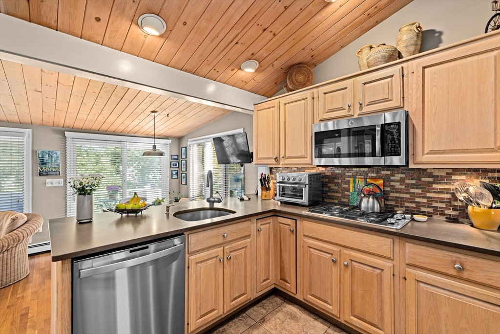 14 Aberdeen Drive Scituate, MA 02066 - Photo 16 of 42 a kitchen with stainless steel appliances a sink a counter space cabinets and a window