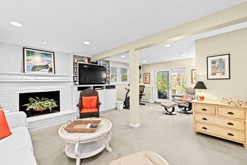 14 Aberdeen Drive Scituate, MA 02066 - Photo 24 of 42 a living room with furniture a fireplace and a flat screen tv