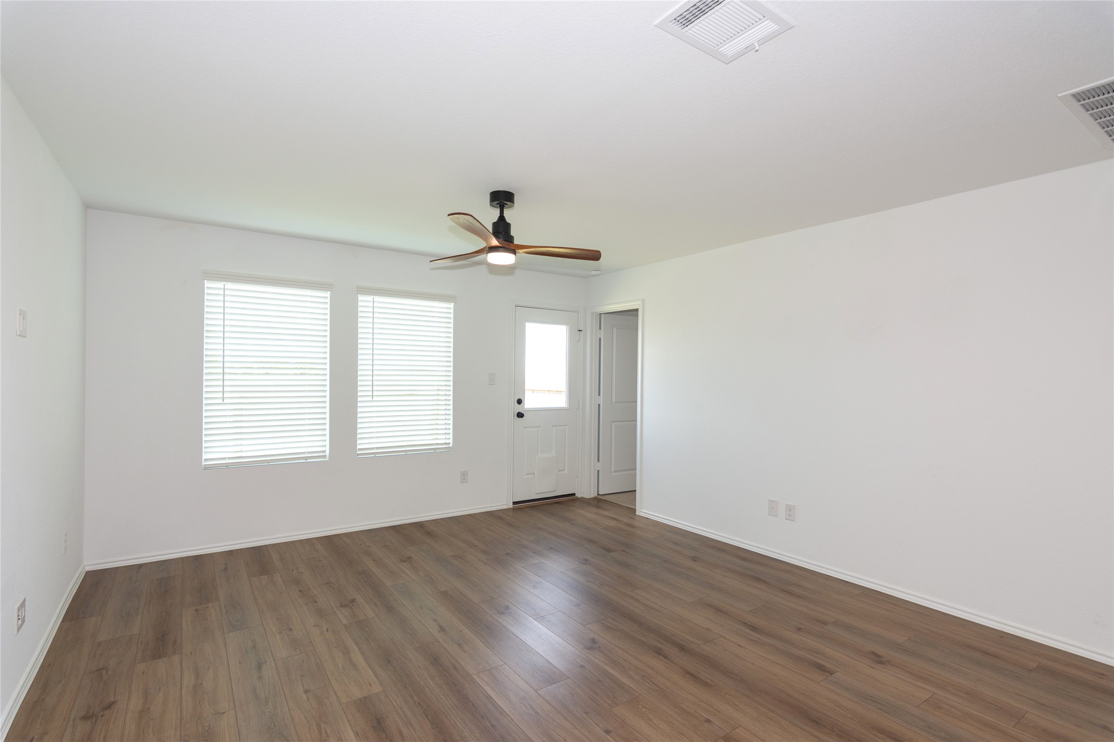 548 Rancho Del Cielo Loop Jarrell, TX 76537 - Photo 13 of 40 The living room is filled with natural light.