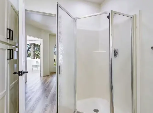 a bathroom with a glass shower door
