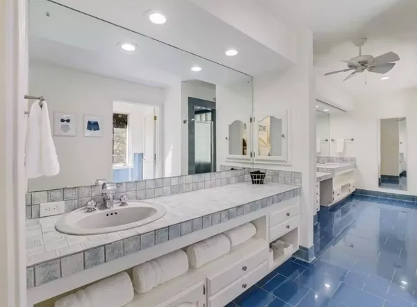 a bathroom with a double vanity sink a mirror and a shower