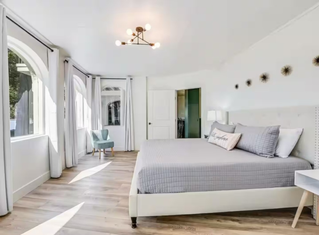 1263 Terminal Loop Road McQueeney, TX 78123 - Photo 26 of 33 a bedroom with a large bed and a chandelier