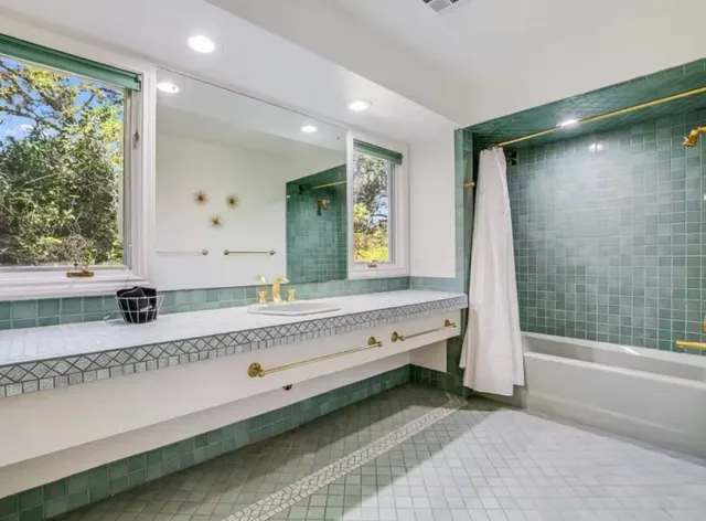 a bathroom with a tub and a sink
