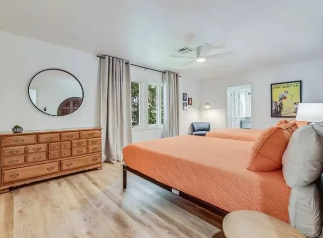 a bedroom with a bed a closet and large mirror