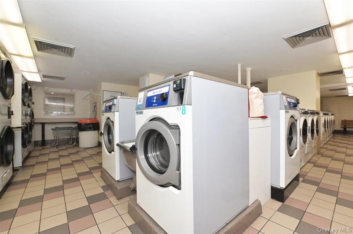 175-20 Wexford Terrace, Unit 16L Queens, NY 11432 - Photo 16 of 26 a utility room with dryer and washer