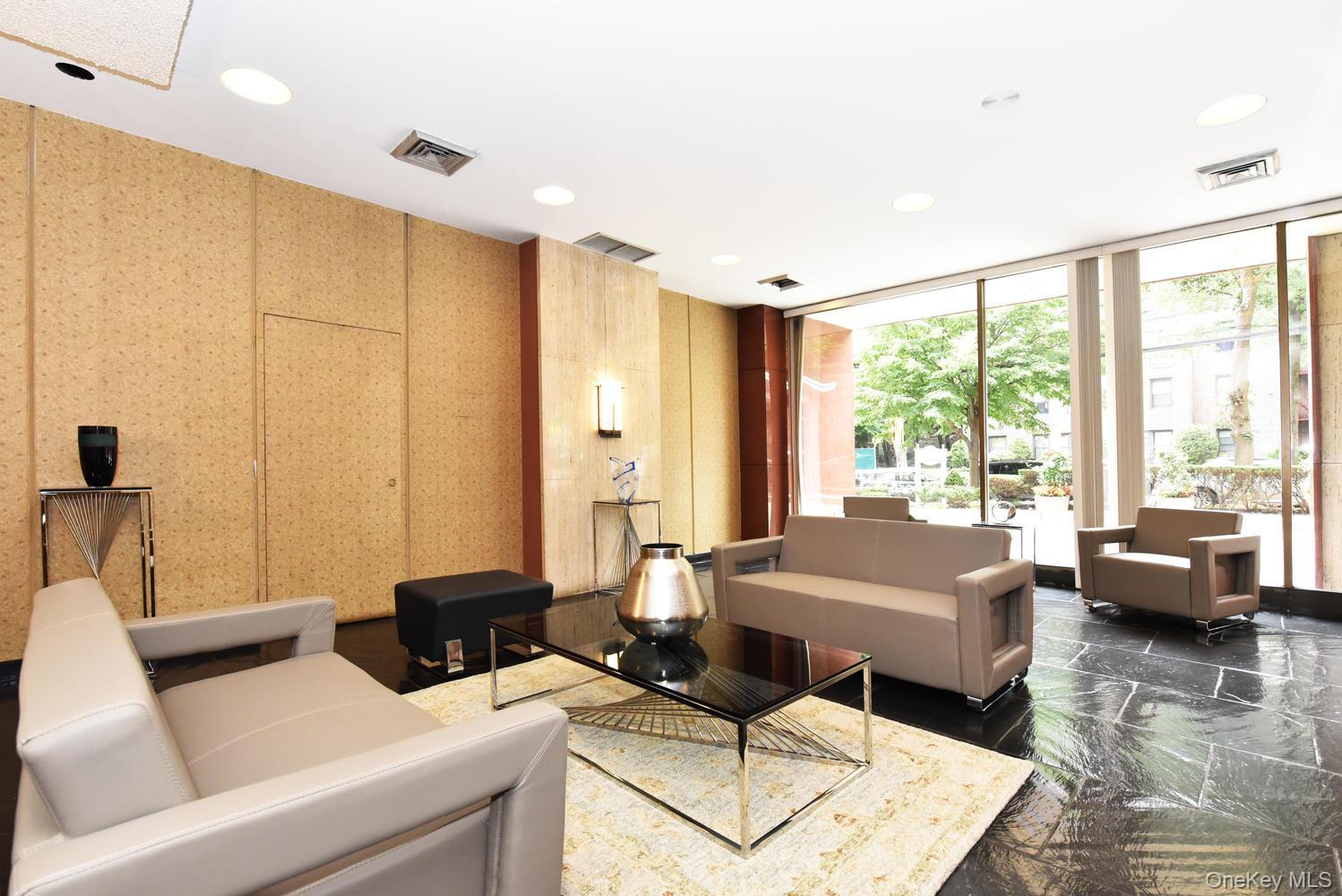 175-20 Wexford Terrace, Unit 16L Queens, NY 11432 - Photo 24 of 26 a living room with furniture and a large window