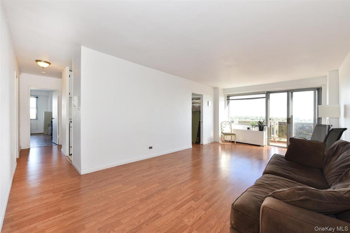 175-20 Wexford Terrace, Unit 16L Queens, NY 11432 - Photo 3 of 26 a living room with furniture and a large window