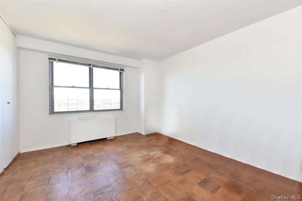 175-20 Wexford Terrace, Unit 16L Queens, NY 11432 - Photo 9 of 26 an empty room with windows