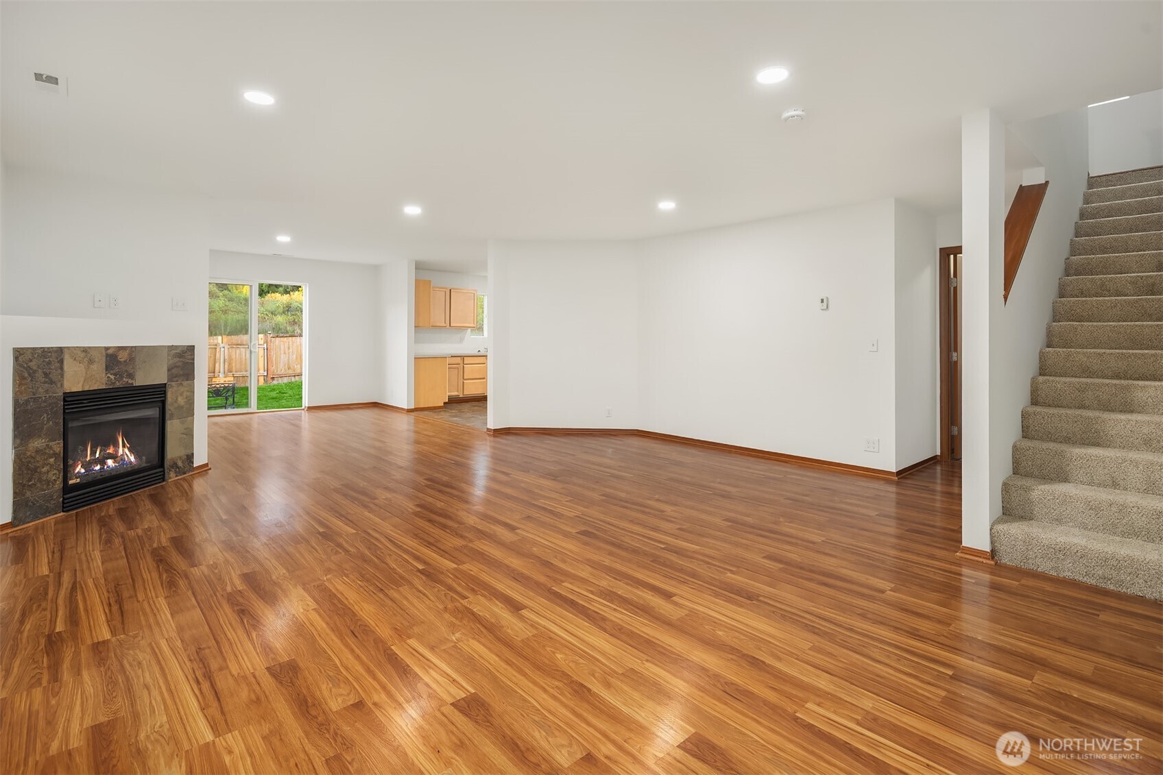 21353 Southeast 289th Way Kent, WA 98042 - Photo 16 of 40 a view of a livingroom with wooden floor and a fireplace