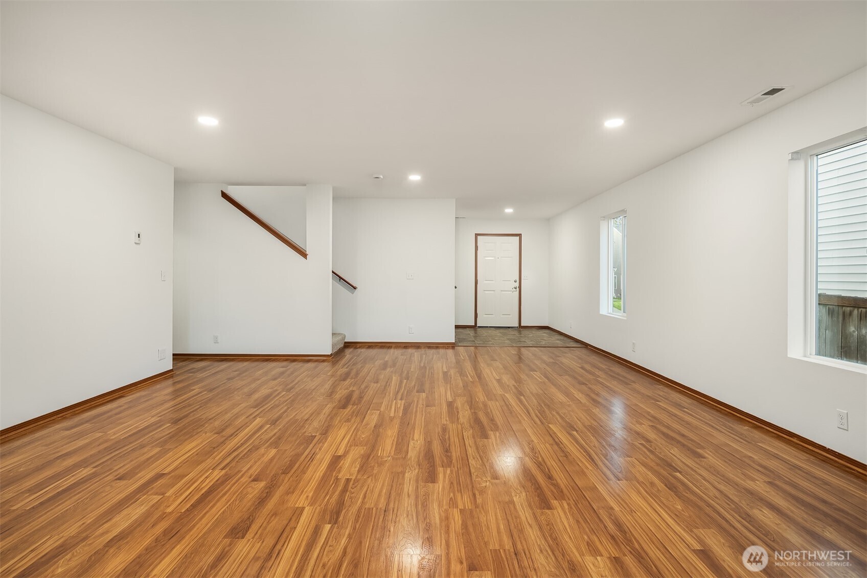 21353 Southeast 289th Way Kent, WA 98042 - Photo 17 of 40 a view of an empty room with wooden floor and a window