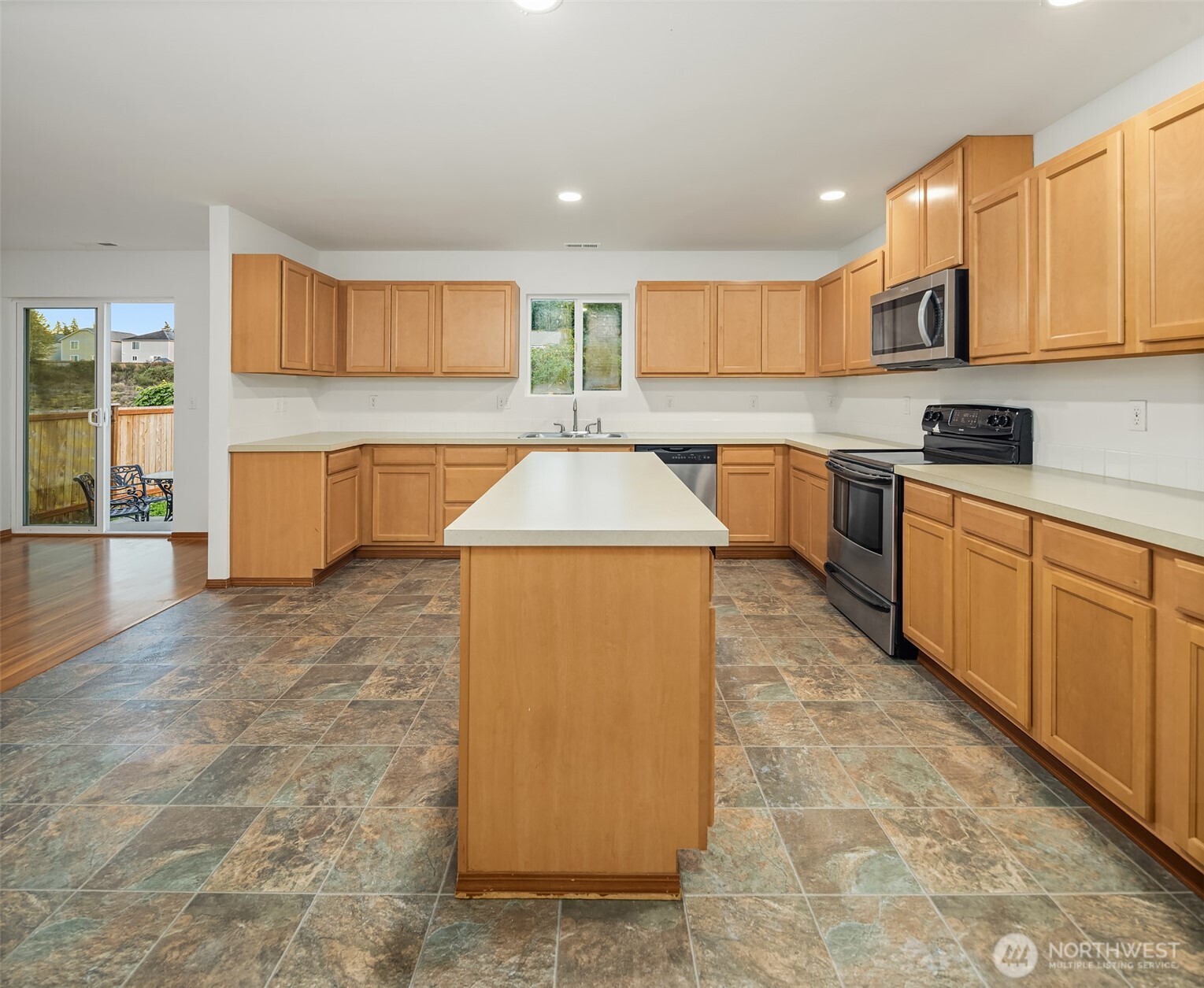 21353 Southeast 289th Way Kent, WA 98042 - Photo 20 of 40 a kitchen with stainless steel appliances granite countertop a stove a sink and a microwave