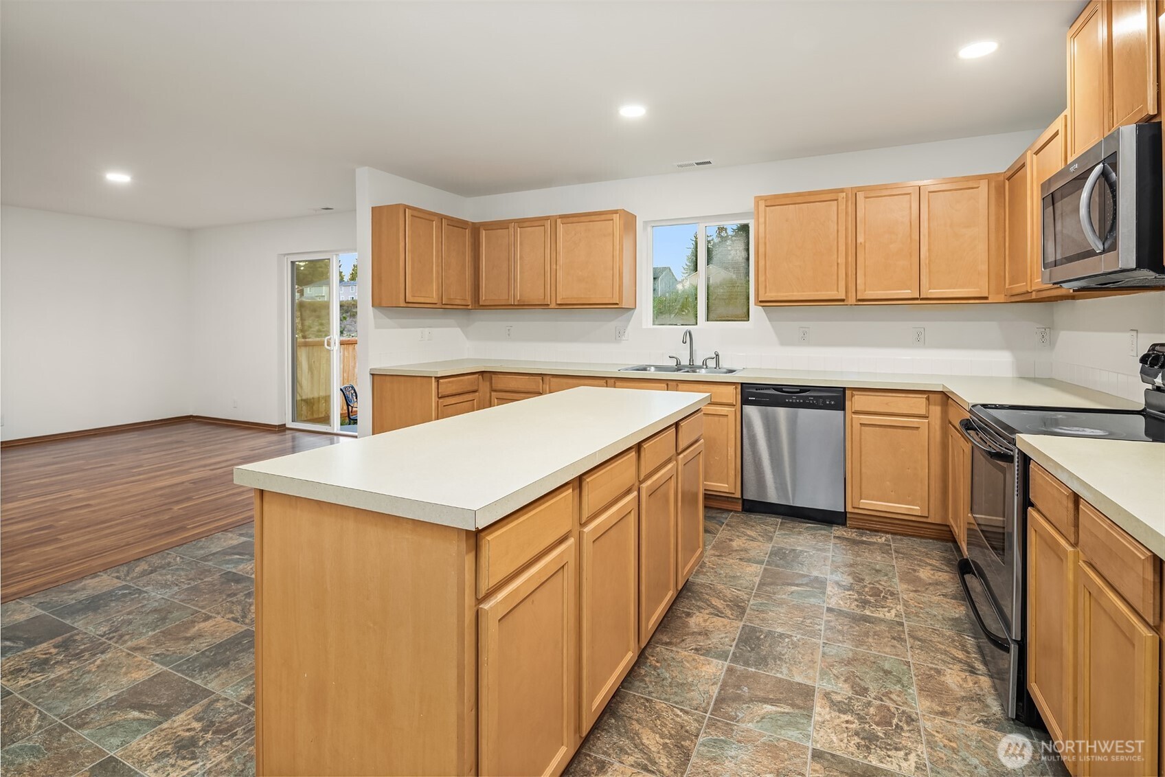 21353 Southeast 289th Way Kent, WA 98042 - Photo 22 of 40 a kitchen with stainless steel appliances granite countertop a sink counter space cabinets and a large window