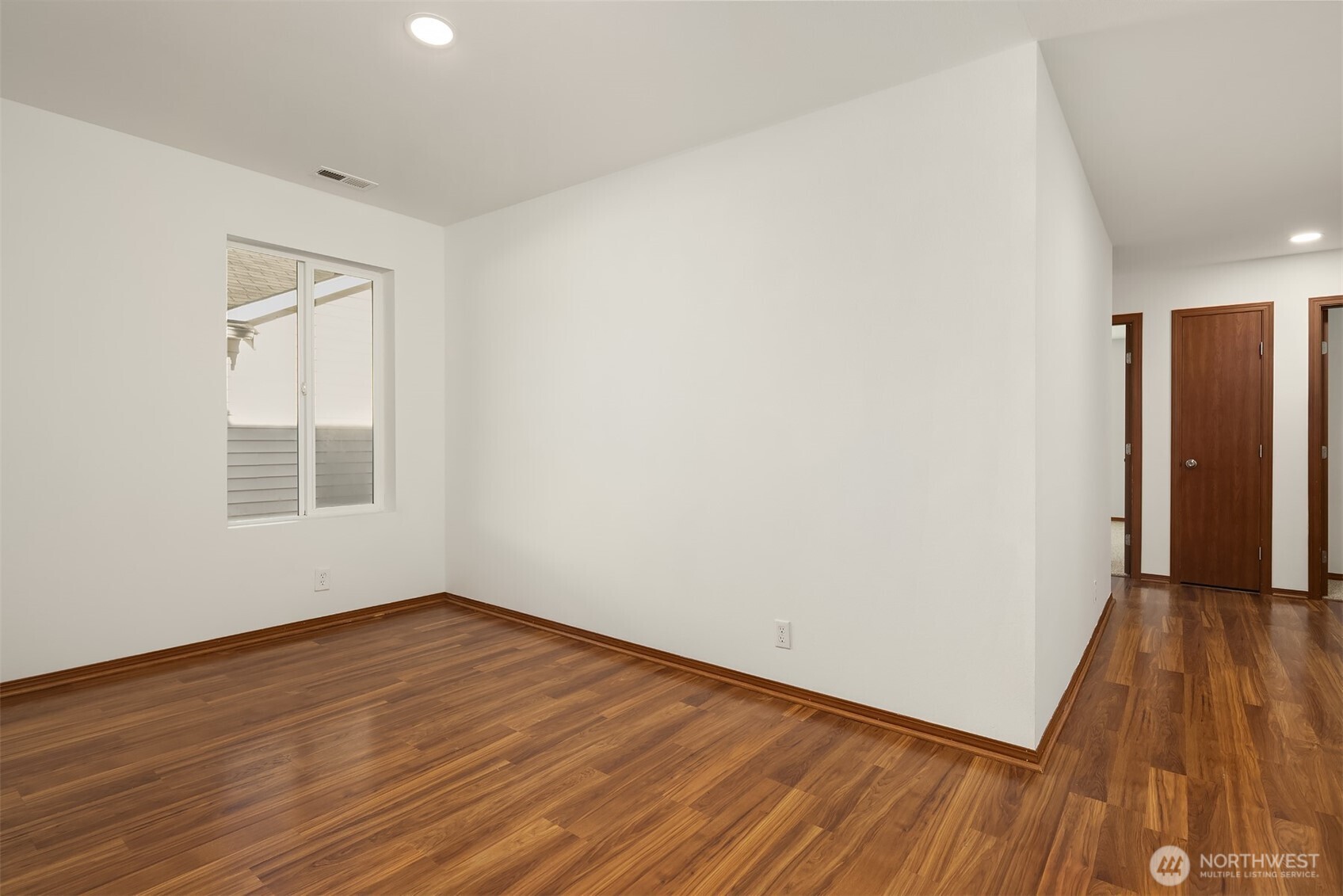 21353 Southeast 289th Way Kent, WA 98042 - Photo 29 of 40 an empty room with wooden floor and windows
